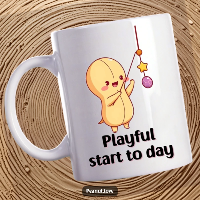 Funny peanut character playfully batting at a dangling string like a toy on a mug, energetic and fun design.