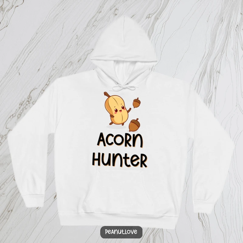 Funny hoodie design: a kawaii peanut with a determined expression stretching out to grab a falling acorn.
