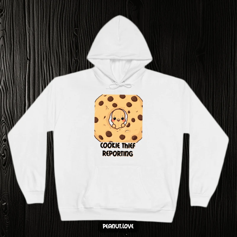 Funny hoodie with a peanut character peeking from behind a large chocolate chip cookie, a cozy and humorous design for treat lovers.