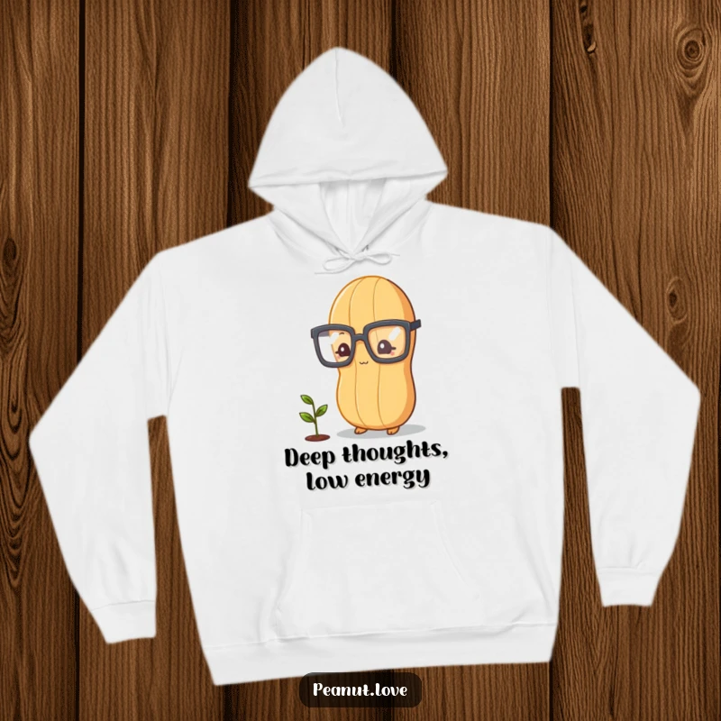 Funny peanut character with oversized glasses, studying a tiny plant sprout, cozy and humorous hoodie design.