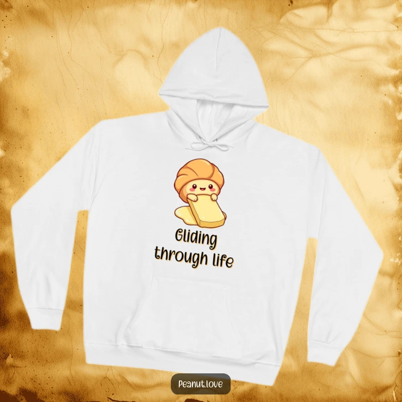 Funny hoodie with a cute croissant character sliding down a butter pat.