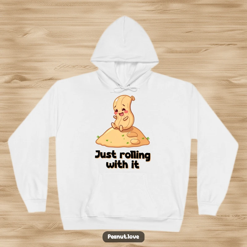 Funny peanut character joyfully rolling down a hill, depicted on a comfortable hoodie, fun and energetic design.