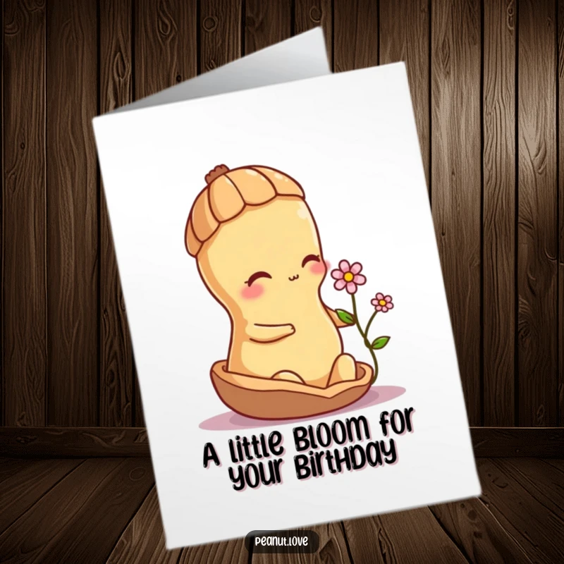 Free Printable Birthday Card: A shy peanut character peeks from its shell, tenderly offering a small flower as a birthday wish.