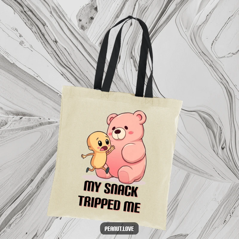 Funny tote bag showcasing a startled peanut character about to trip over a giant gummy bear, perfect for carrying items with a side of hilarious mishap.